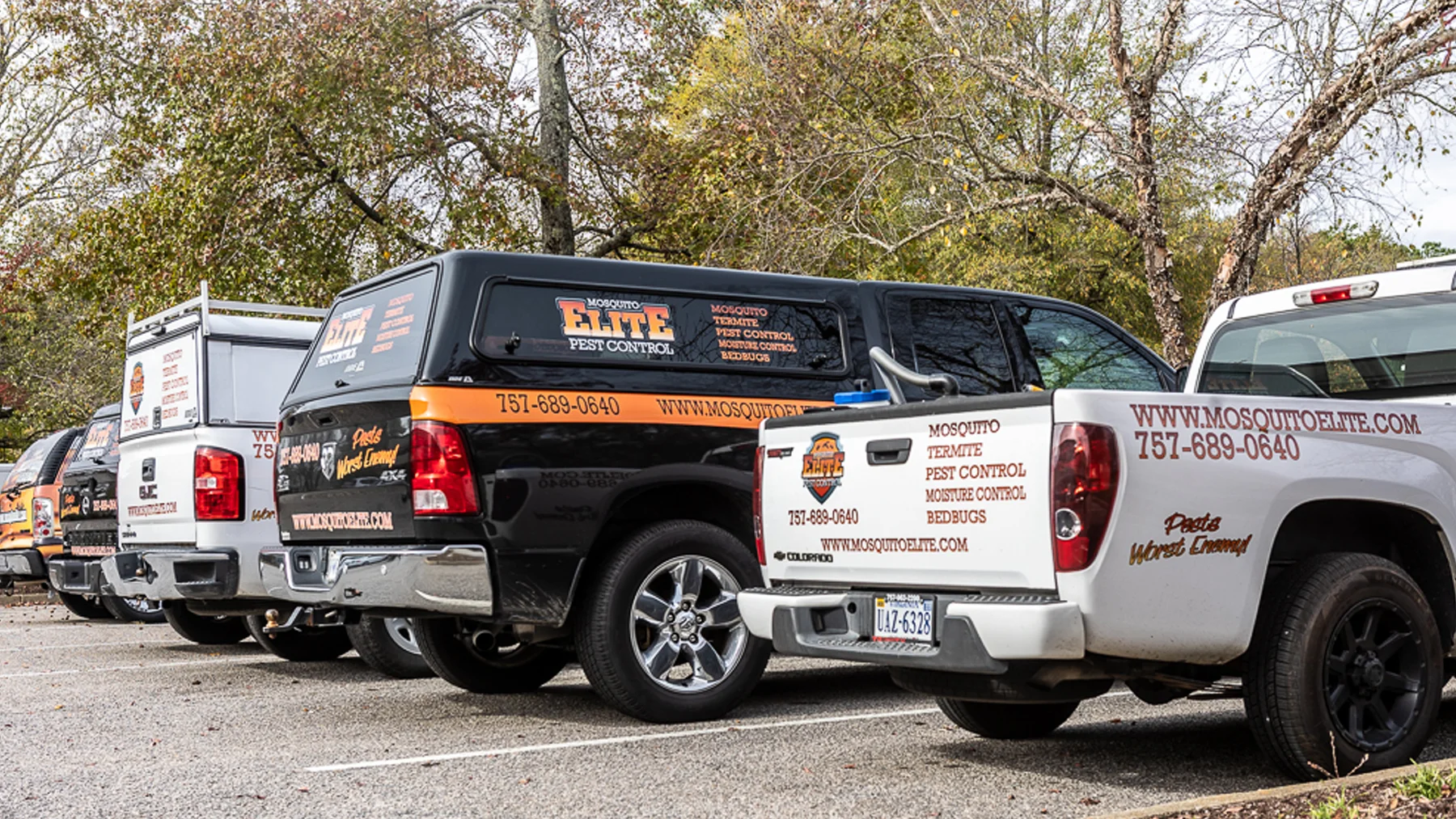 Mosquito Elite Pest Control vehicles lined up in the parking lot